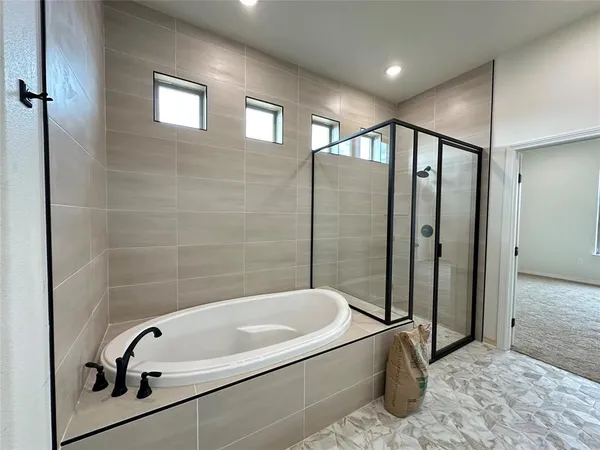 a bathroom with a tub and a shower