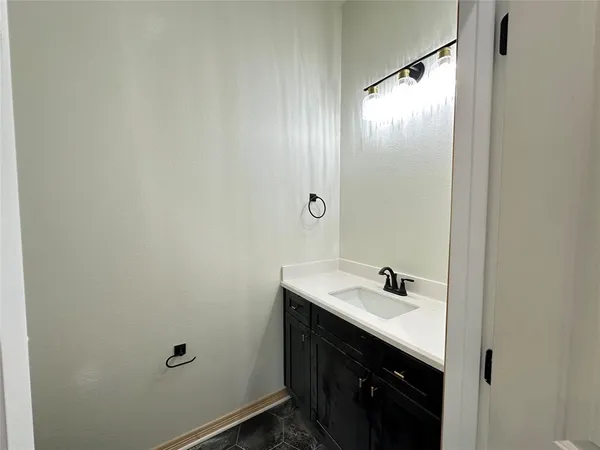 a bathroom with a sink and mirror