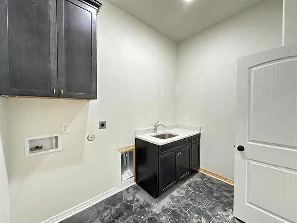 a room with a sink and cabinets