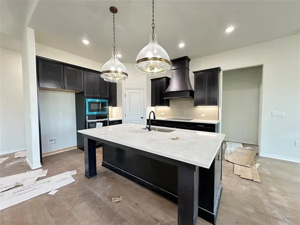 a large kitchen with a table and chairs