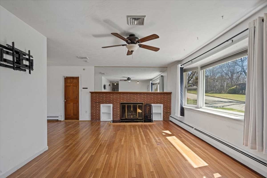77 Zenith Drive Worcester, MA 01602 - Photo 12 of 40 a living room with a fireplace and wooden floor