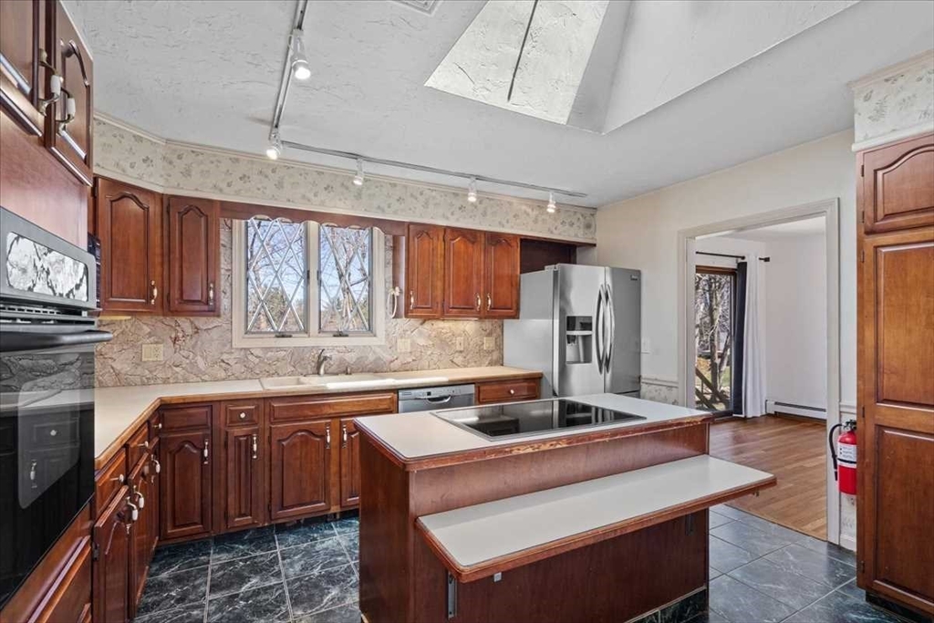 77 Zenith Drive Worcester, MA 01602 - Photo 15 of 40 a kitchen with stainless steel appliances granite countertop a sink stove and refrigerator