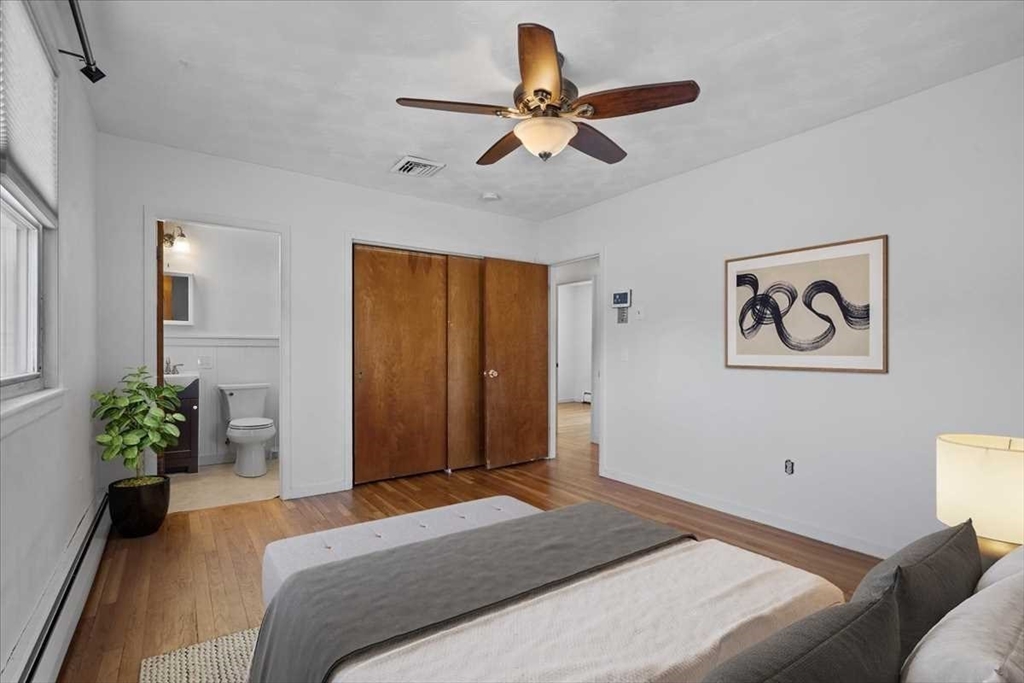 77 Zenith Drive Worcester, MA 01602 - Photo 19 of 40 a bedroom with a bed and a chandelier