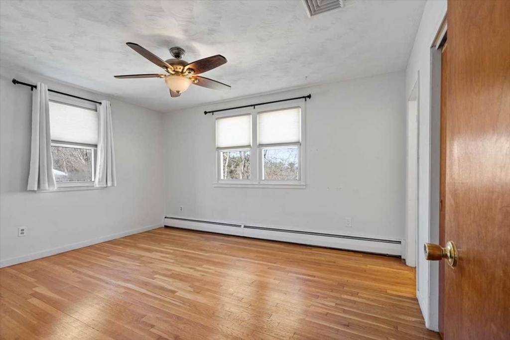 77 Zenith Drive Worcester, MA 01602 - Photo 21 of 40 a view of empty room with wooden floor and fan