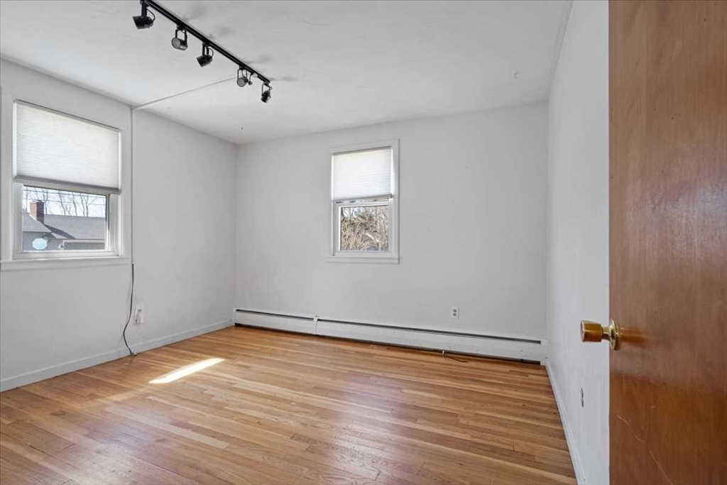 77 Zenith Drive Worcester, MA 01602 - Photo 23 of 40 an empty room with wooden floor and windows