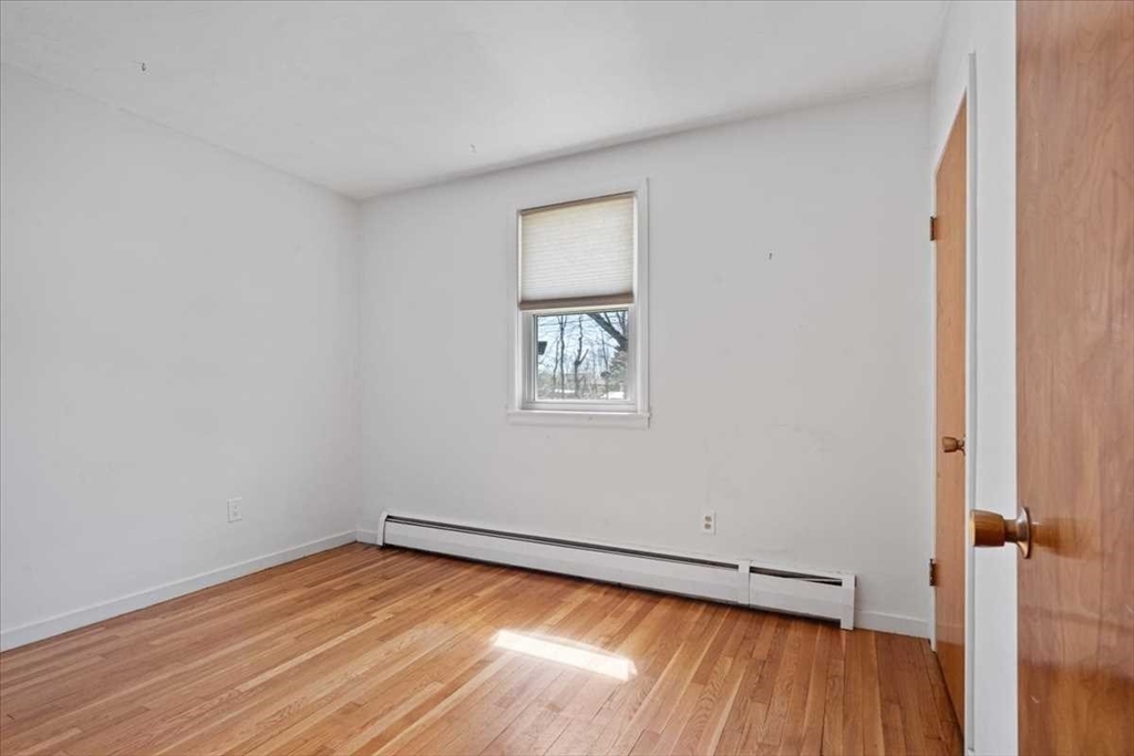 77 Zenith Drive Worcester, MA 01602 - Photo 27 of 40 a view of empty room with wooden floor and fan