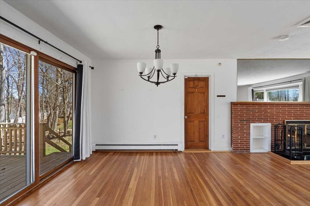 77 Zenith Drive Worcester, MA 01602 - Photo 10 of 40 a view of empty room with wooden floor and fireplace