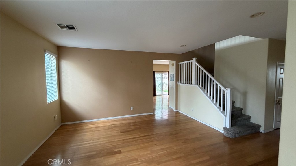 7134 Cumberland Place Rancho Cucamonga, CA 91739 - Photo 2 of 22 a view of an empty room with wooden floor