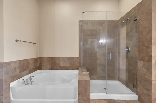 a bathroom with a bathtub and a shower