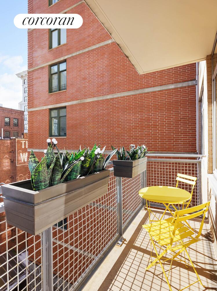 84 Front Street, Unit 7F Brooklyn, NY 11201 - Photo 11 of 12 a view of a brick house with a small yard