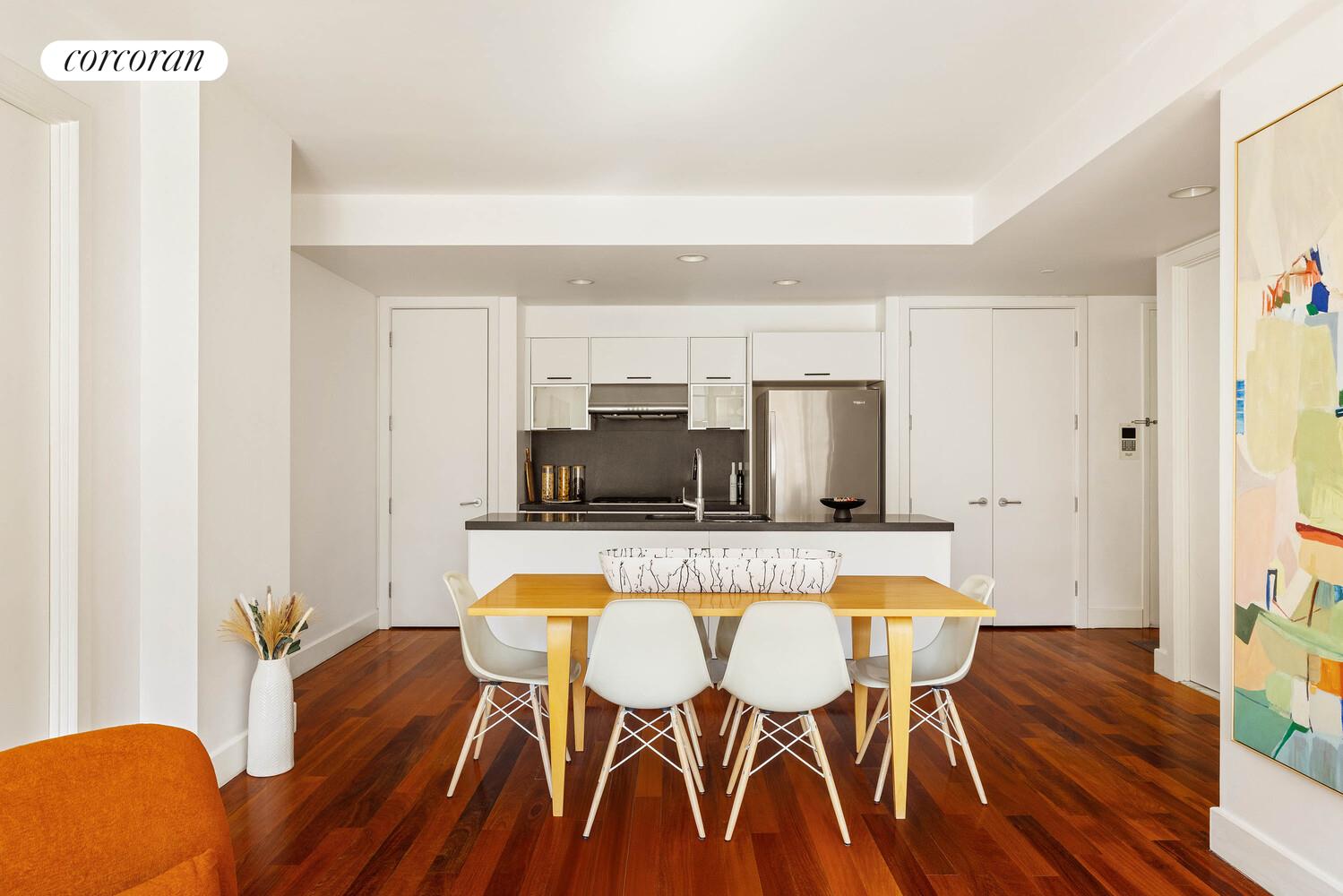 84 Front Street, Unit 7F Brooklyn, NY 11201 - Photo 3 of 12 a kitchen with stainless steel appliances granite countertop a table chairs microwave and sink