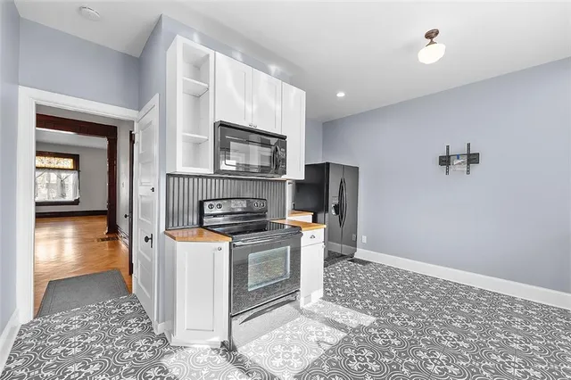 a kitchen with stainless steel appliances a stove a refrigerator sink and microwave