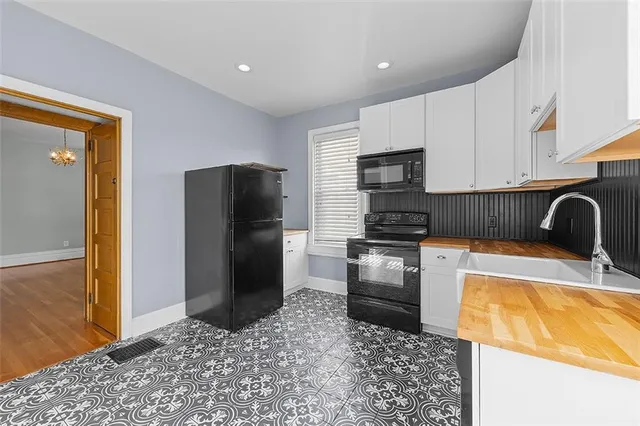 a kitchen with a refrigerator sink and stove