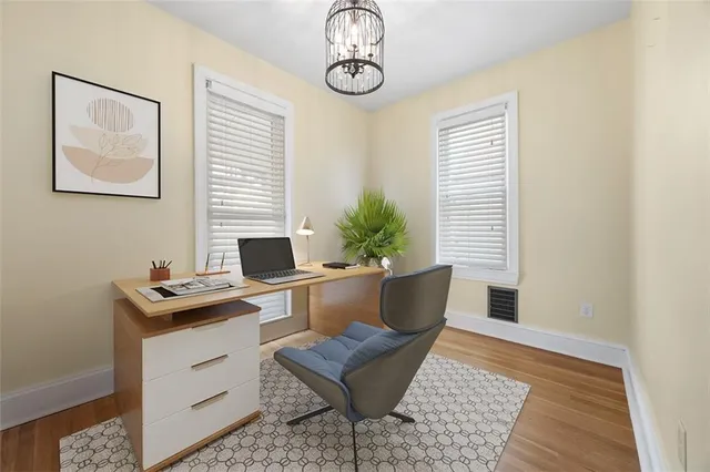 a view of a workspace with furniture and a window