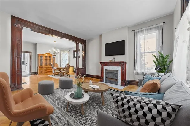 a living room with furniture a fireplace and a flat screen tv