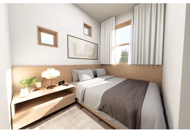 a bed room with a bed and a window