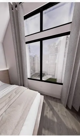 a bed sitting in a bedroom next to a window