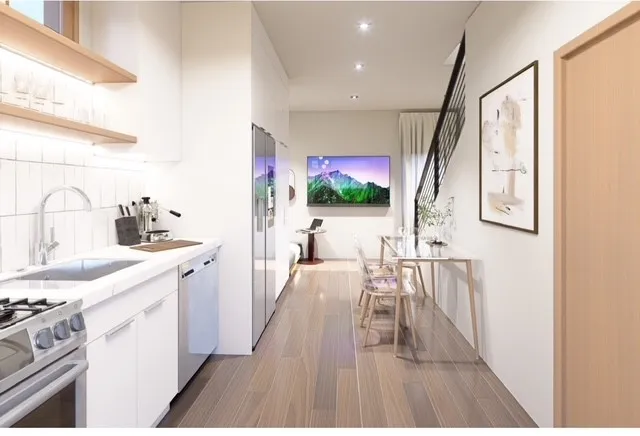 a open kitchen with white cabinets stove and sink