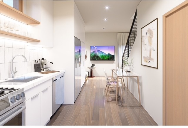 605 East 55th Street Austin, TX 78751 - Photo 4 of 5 a open kitchen with white cabinets stove and sink