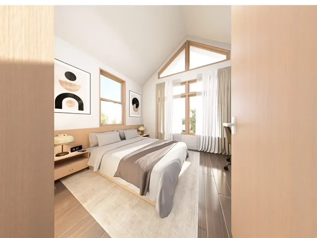 a bedroom with a bed and a large window