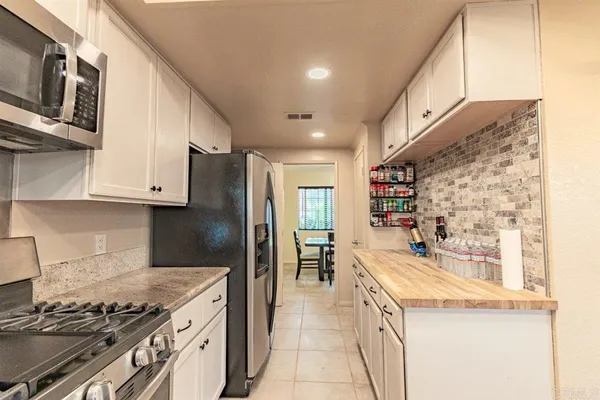a kitchen with stainless steel appliances granite countertop a stove and a refrigerator
