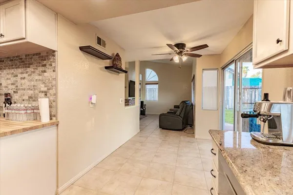 a kitchen with stainless steel appliances a refrigerator a sink a stove and a refrigerator with wooden floor