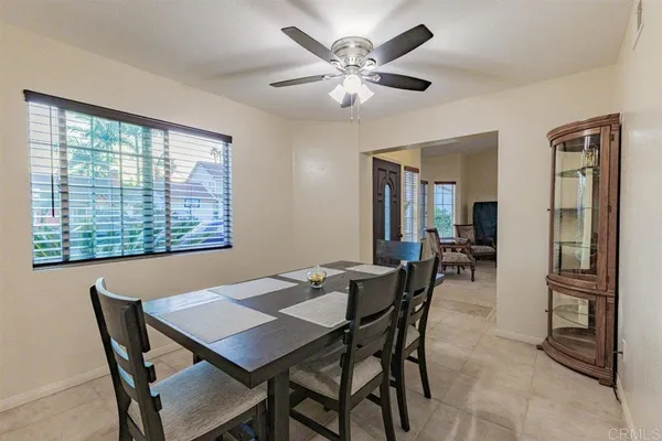 a view of a dining room with furniture and a large window