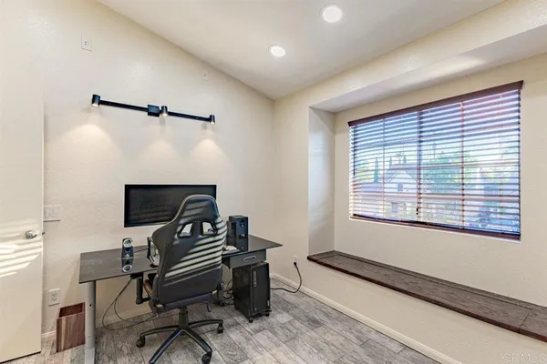 a view of a workspace with furniture and a window