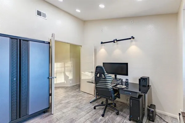 a view of a workspace with furniture and a window