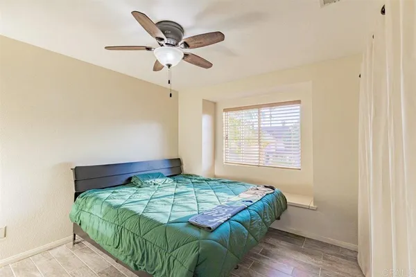 a bedroom with a bed and window