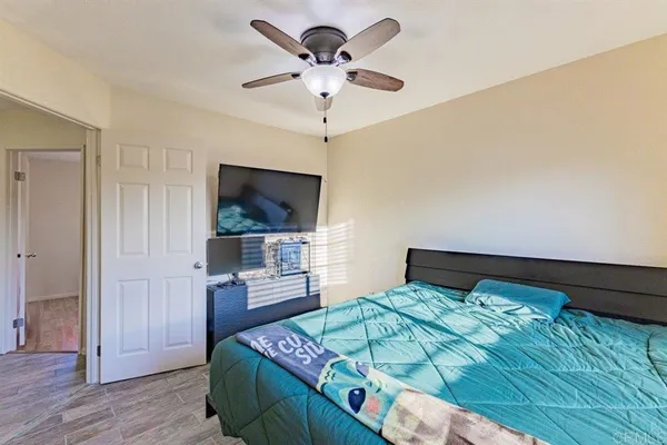 a bedroom with a bed and a flat screen tv