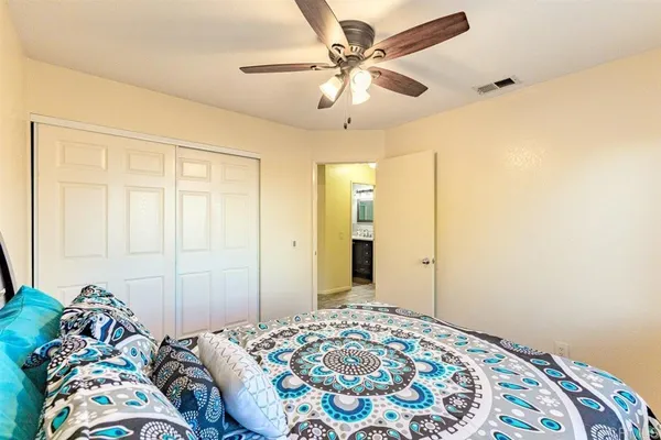 a bedroom with a bed and a chandelier