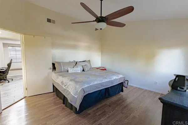 a bedroom with a bed and a tv