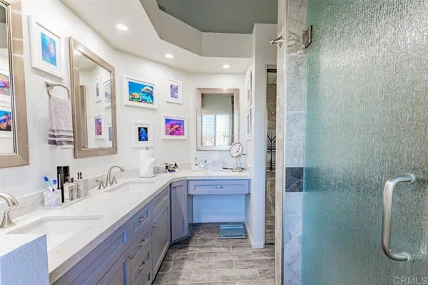 a spacious bathroom with a bathtub sink mirror and shower