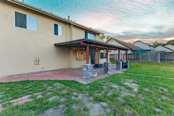 a view of a house with a yard and sitting area