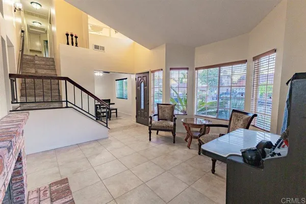 a room with furniture pool table and windows