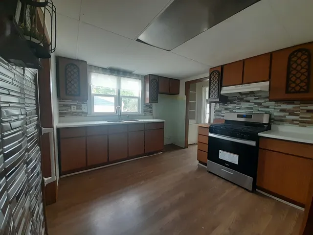 a kitchen with stainless steel appliances granite countertop a stove and a sink