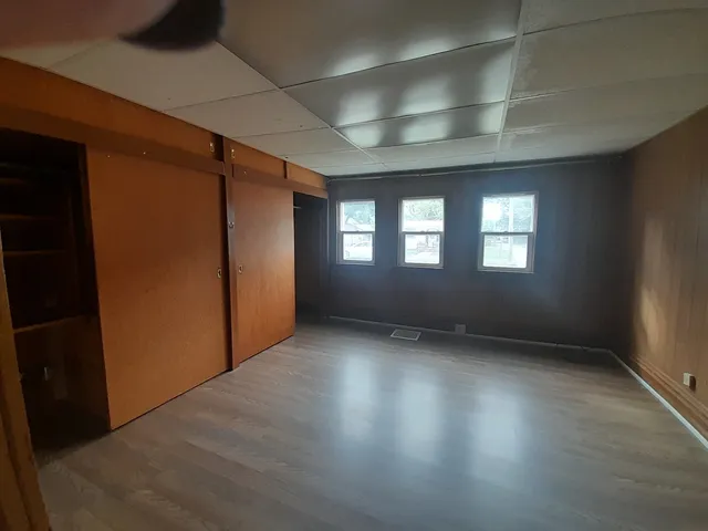 a view of wooden floor and windows in an empty room