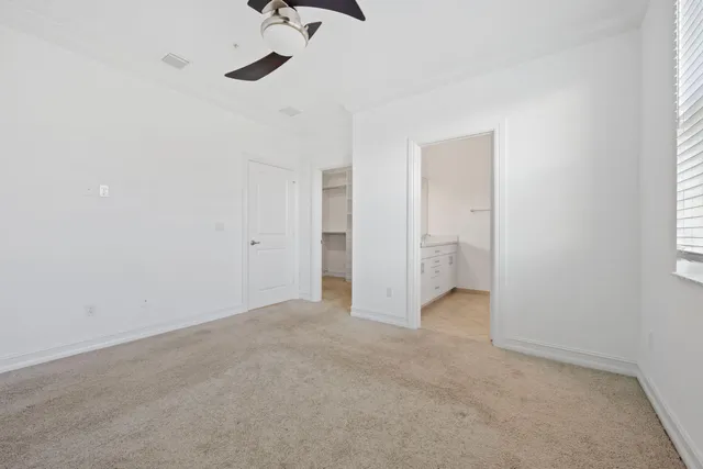 a view of empty room with ceiling fan
