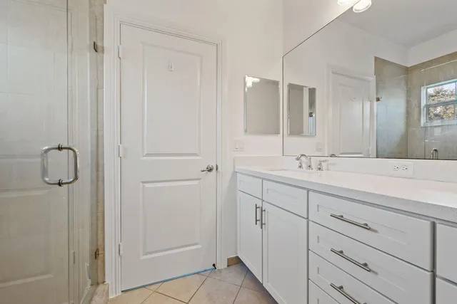 a bathroom with a double vanity sink and mirror