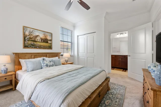 a bedroom with bed and a chandelier