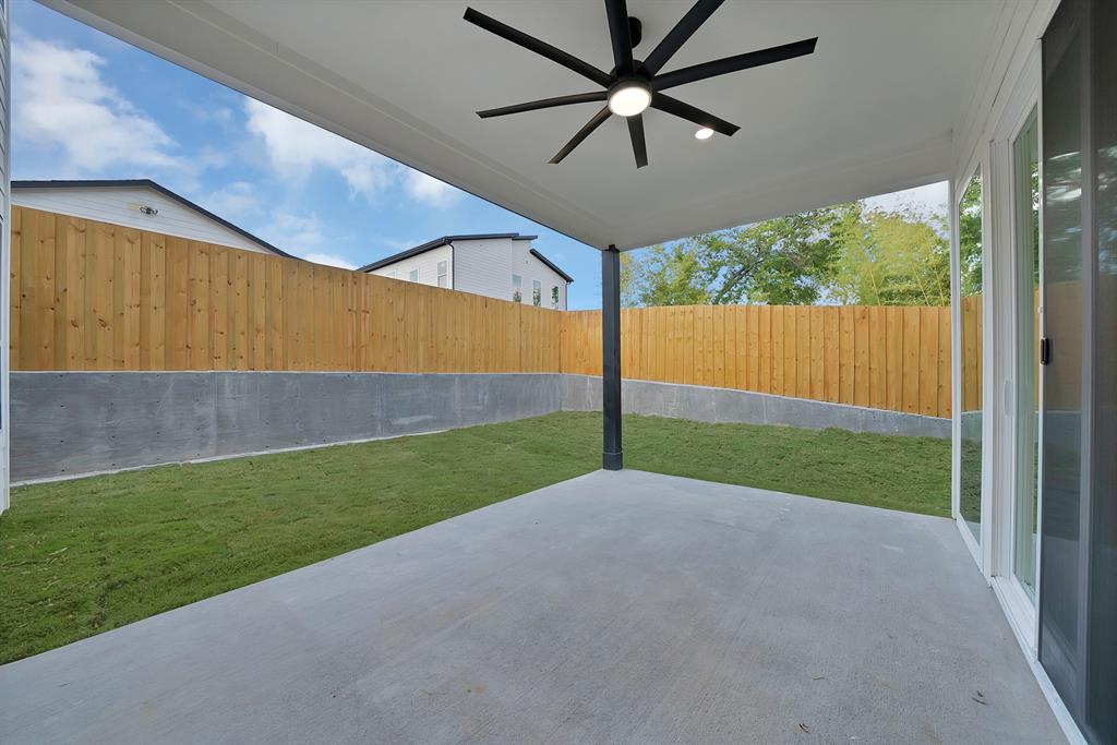1415 Fayette Street Dallas, TX 75203 - Photo 40 of 40 Covered patio featuring a ceiling fan with integrated lighting, concrete flooring, and a grass area