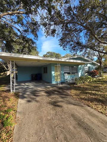 a view of a house with a space and a tree