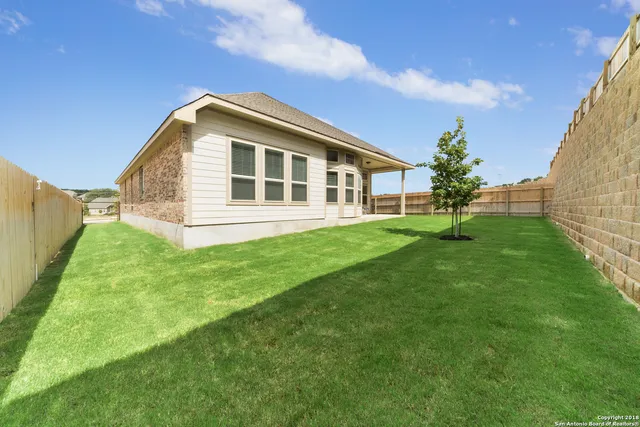 a view of a house with a backyard