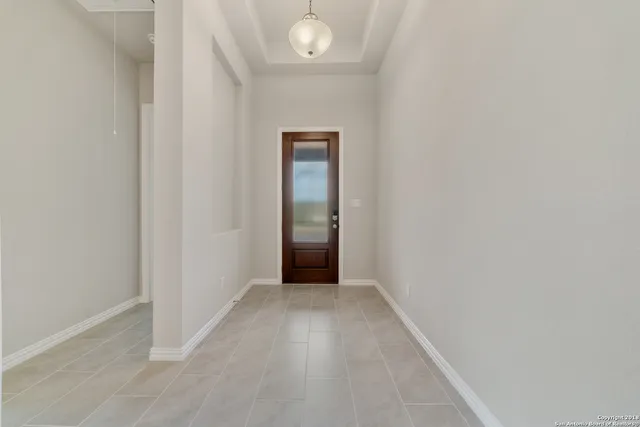 a view of hallway with wooden floor