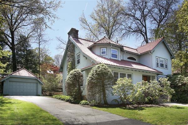 280 Clark Road Brookline, MA 02445 - Photo 12 of 13 a front view of a house with a garden and trees