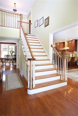280 Clark Road Brookline, MA 02445 - Photo 8 of 13 a view of staircase with lots of frames on wall and a dining table