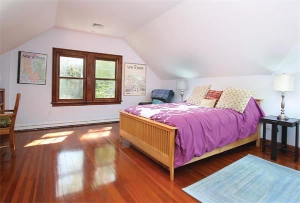 280 Clark Road Brookline, MA 02445 - Photo 10 of 13 a bedroom with a bed and a chandelier