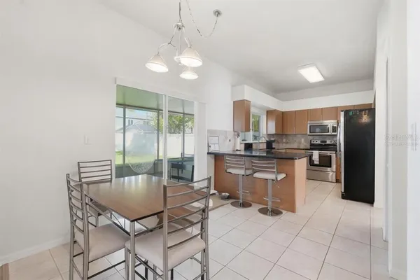 a kitchen with stainless steel appliances granite countertop a sink a stove and a refrigerator
