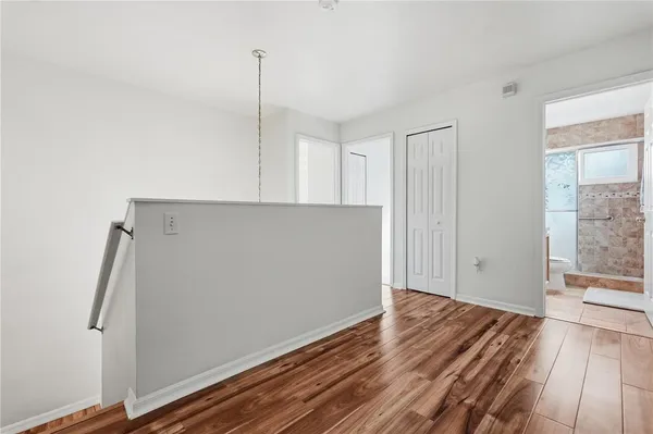 an empty room with a window and a ceiling fan